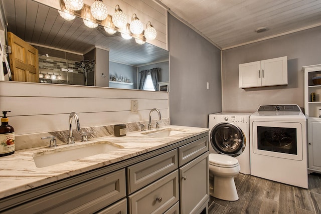 bathroom with wooden ceiling, separate washer and dryer, hardwood / wood-style floors, toilet, and vanity