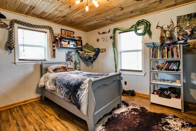 bedroom featuring wood-type flooring, wooden ceiling, and wood walls