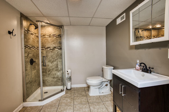 bathroom featuring tile patterned floors, vanity, a shower with shower door, and toilet