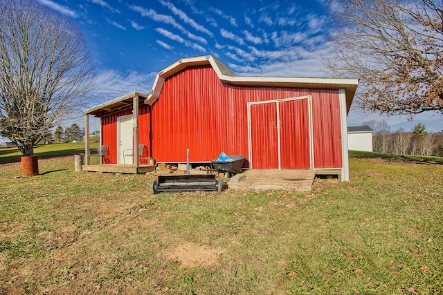 view of outbuilding featuring a yard