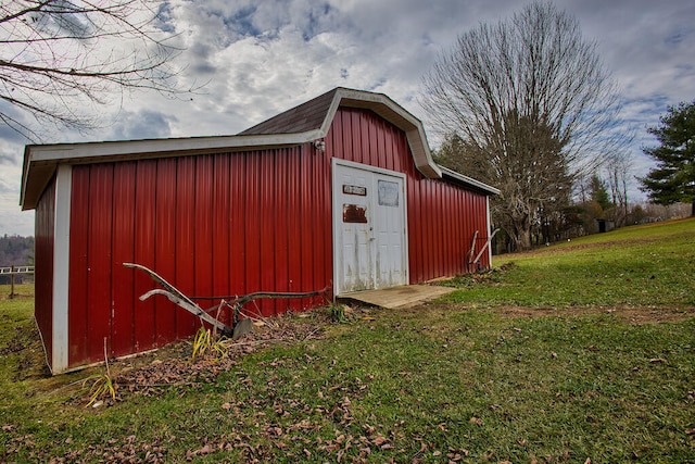 view of outbuilding featuring a yard