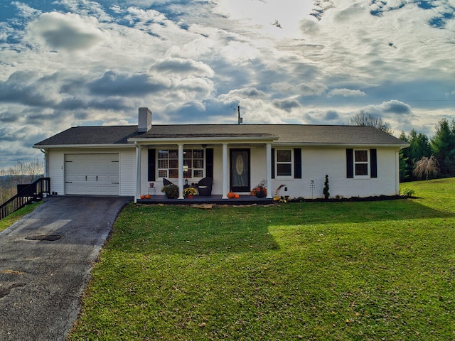 ranch-style home with a front lawn, covered porch, and a garage