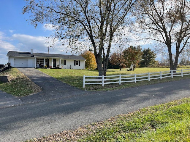 view of front facade with a garage and a front lawn