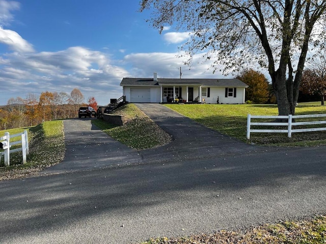 single story home featuring a garage and a front yard