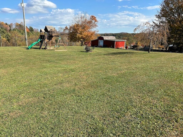 view of yard with a playground and an outdoor structure