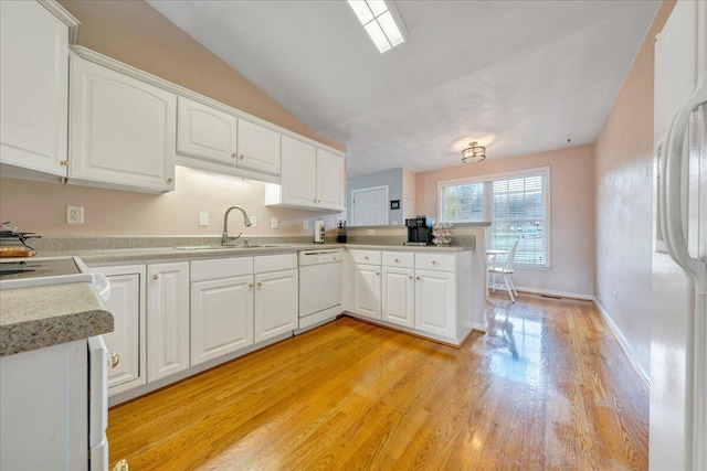 kitchen featuring white cabinetry, sink, light hardwood / wood-style floors, and white appliances