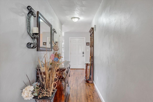 hall with hardwood / wood-style floors