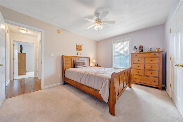 bedroom with ceiling fan and light colored carpet