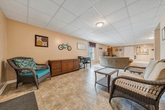 living room featuring a drop ceiling