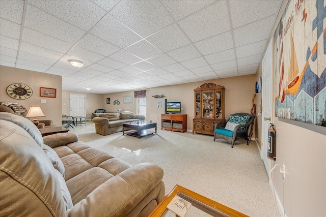 carpeted living room with a drop ceiling