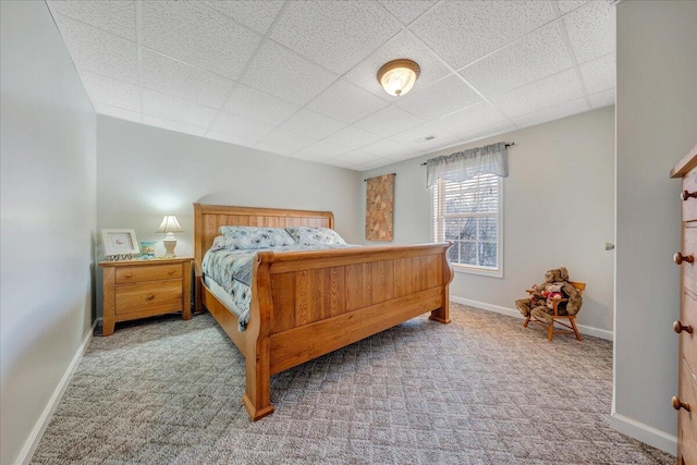 carpeted bedroom featuring a paneled ceiling