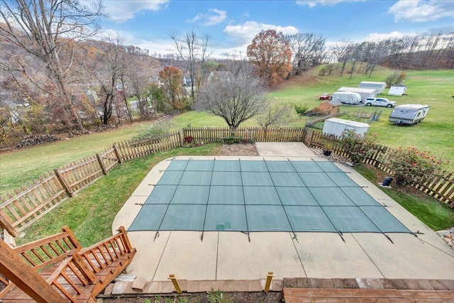 view of pool featuring a lawn