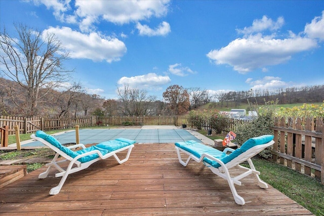 wooden terrace with a covered pool