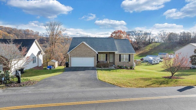 view of front of property with a shed and a front lawn