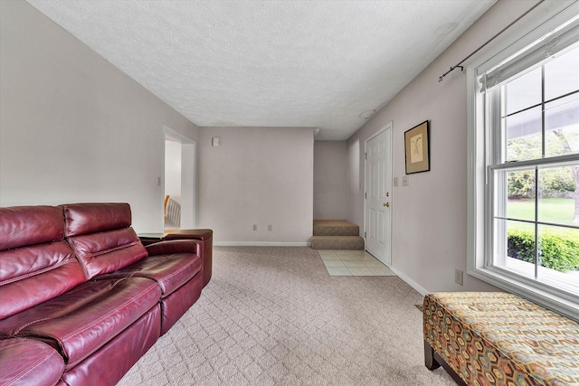 living room with a textured ceiling and light carpet