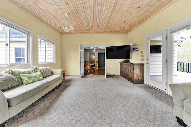 living room featuring carpet, ceiling fan, and wooden ceiling