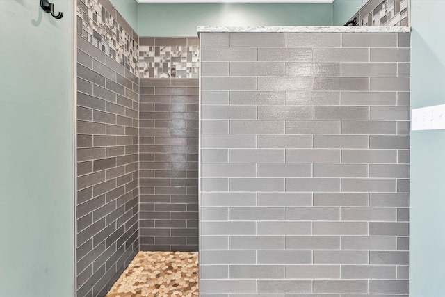 bathroom with tiled shower