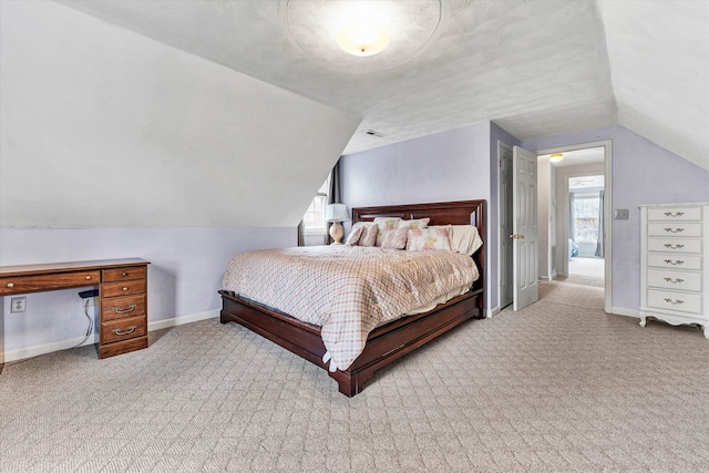 carpeted bedroom with lofted ceiling