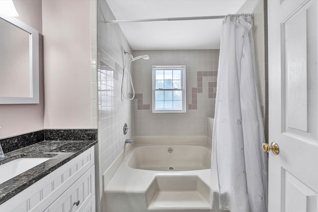 bathroom featuring shower / tub combo and vanity