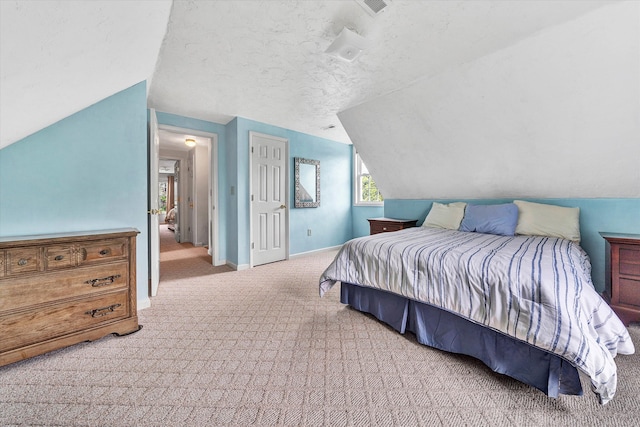 carpeted bedroom featuring lofted ceiling and a textured ceiling