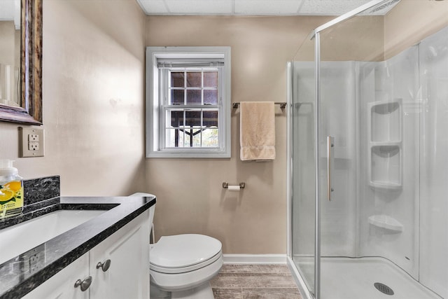 bathroom featuring hardwood / wood-style floors, vanity, an enclosed shower, and toilet