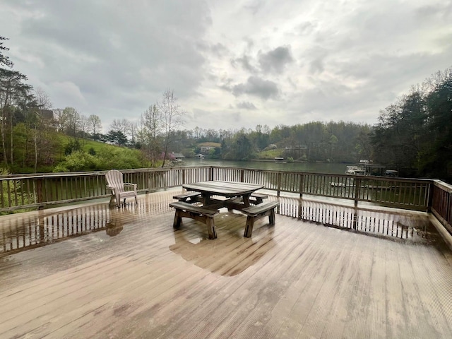 wooden terrace featuring a water view