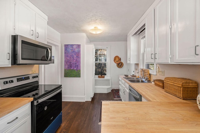 kitchen featuring white cabinetry, dark hardwood / wood-style flooring, sink, and appliances with stainless steel finishes