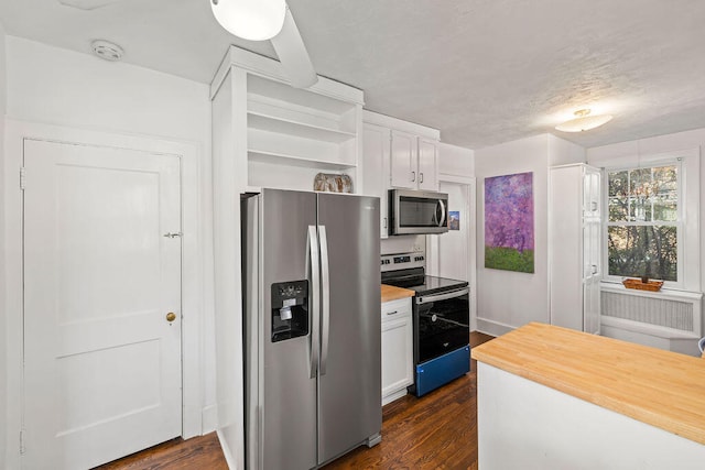 kitchen with white cabinets, dark wood-type flooring, and appliances with stainless steel finishes