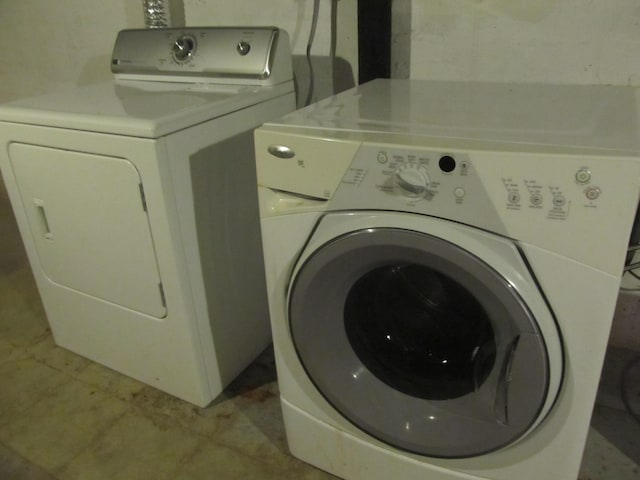 laundry room featuring separate washer and dryer and light tile patterned floors