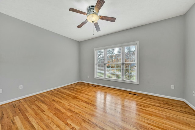 spare room with light wood-type flooring and ceiling fan