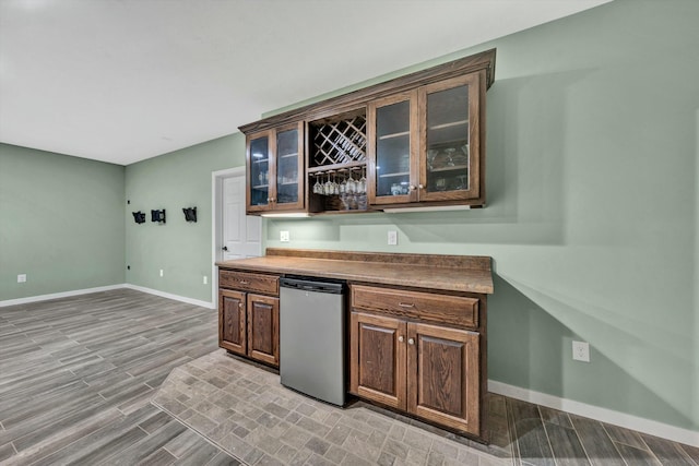 bar featuring stainless steel fridge and light wood-type flooring