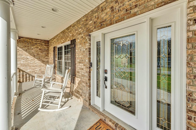 view of exterior entry featuring a porch