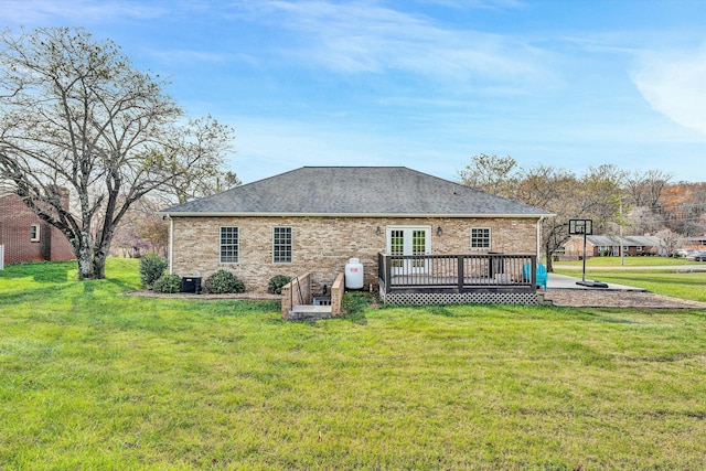 rear view of property featuring central AC, a lawn, and a wooden deck