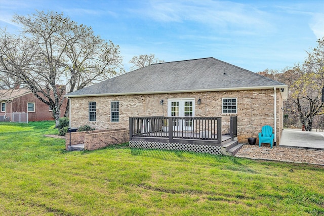 rear view of property featuring a yard and a wooden deck