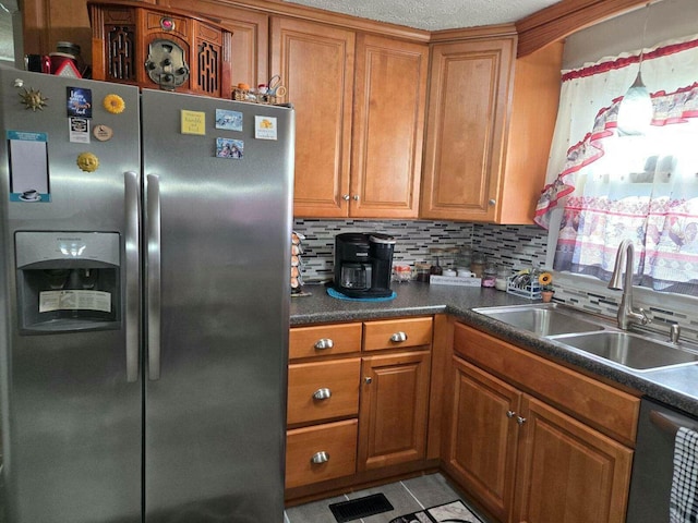 kitchen featuring light tile patterned flooring, appliances with stainless steel finishes, sink, and backsplash