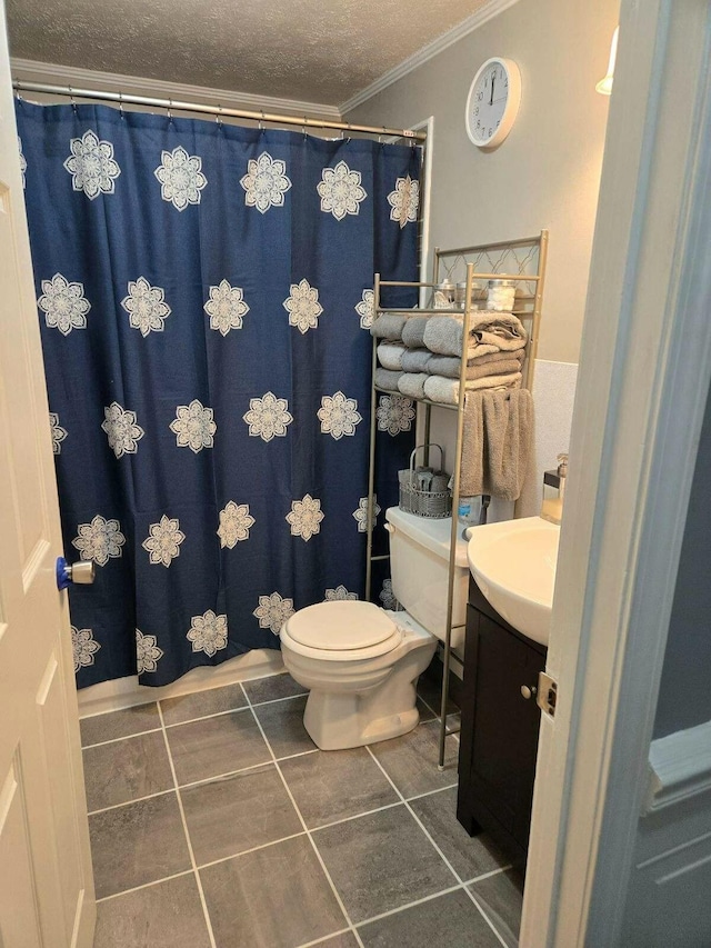 bathroom featuring crown molding, tile patterned flooring, vanity, a textured ceiling, and toilet