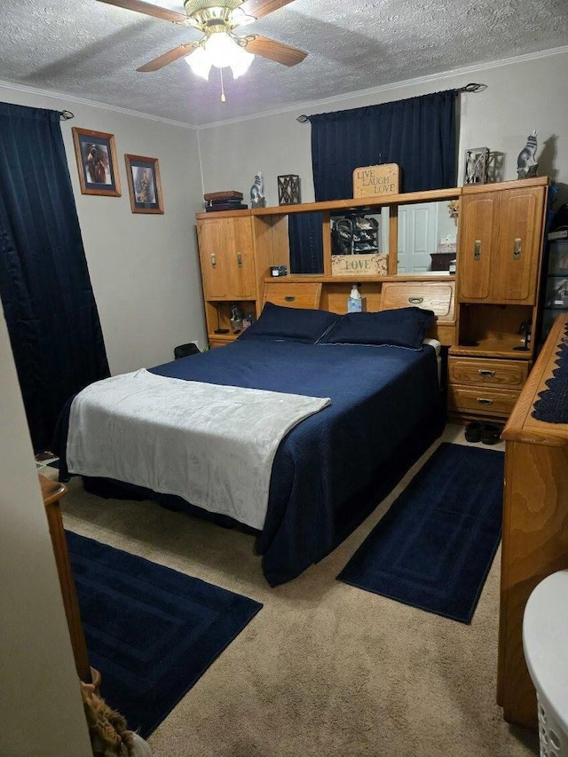 carpeted bedroom with ceiling fan, ornamental molding, and a textured ceiling