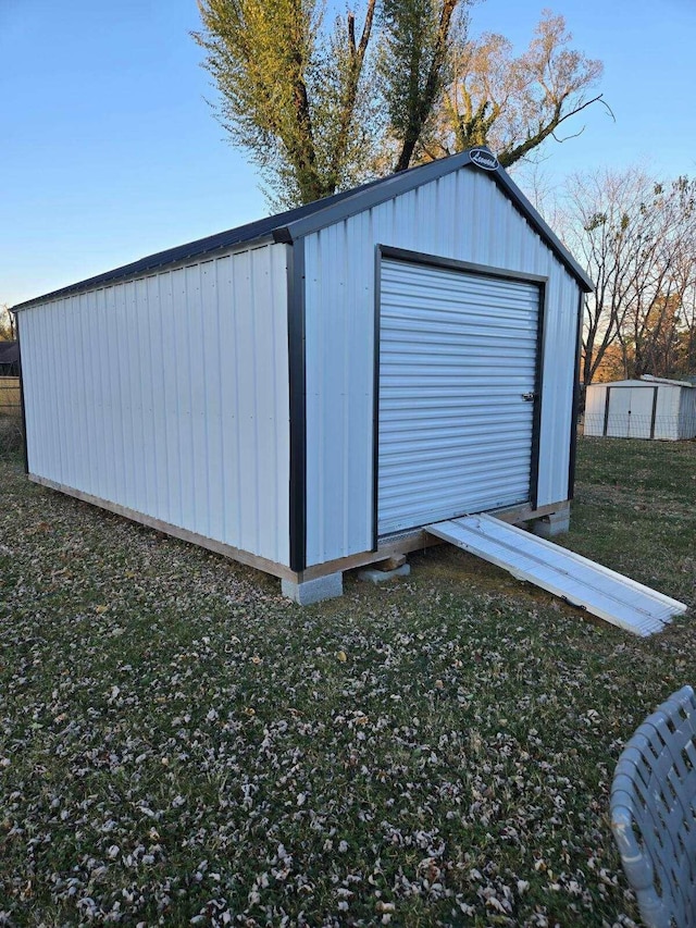 view of outbuilding with a yard