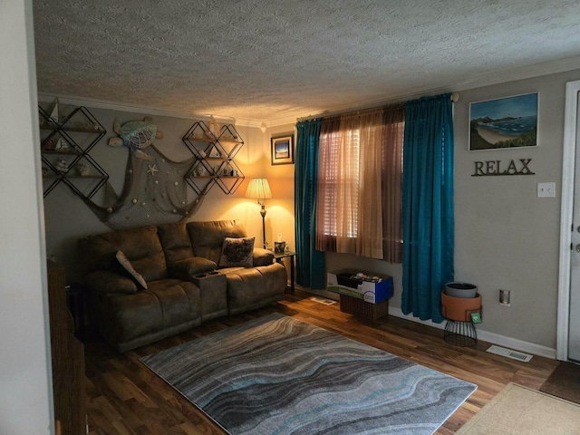 living room with ornamental molding, hardwood / wood-style floors, and a textured ceiling