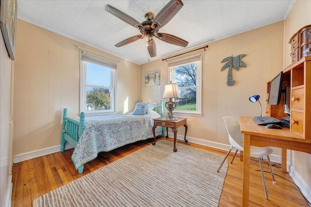 bedroom featuring hardwood / wood-style floors, ceiling fan, and ornamental molding