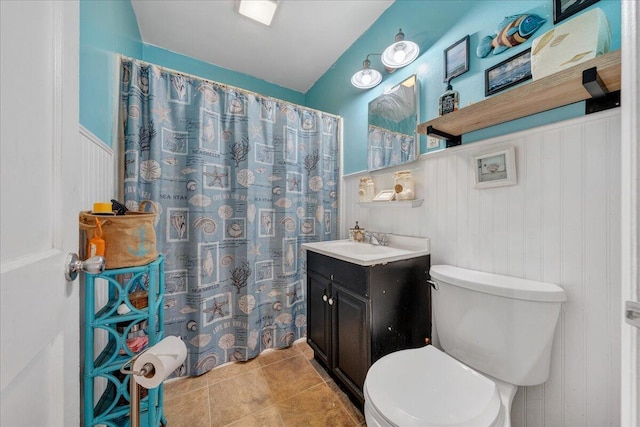 bathroom featuring tile patterned floors, vanity, a shower with shower curtain, and toilet