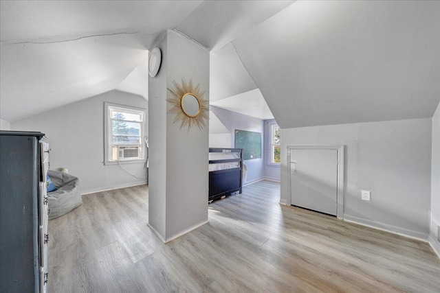 bonus room featuring a wealth of natural light, cooling unit, vaulted ceiling, and light wood-type flooring