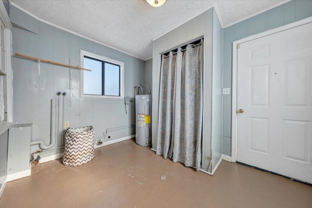 interior space with water heater, concrete flooring, a textured ceiling, wooden walls, and ornamental molding