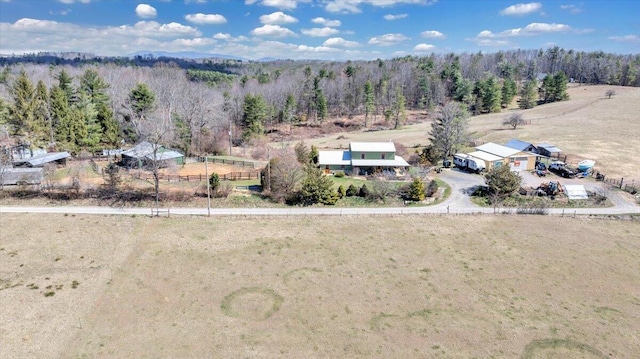 birds eye view of property with a wooded view and a rural view