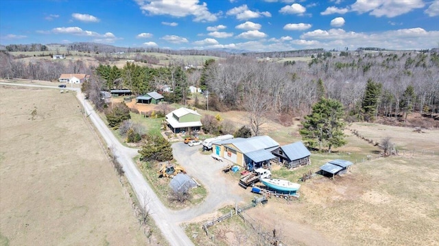 aerial view with a wooded view and a rural view