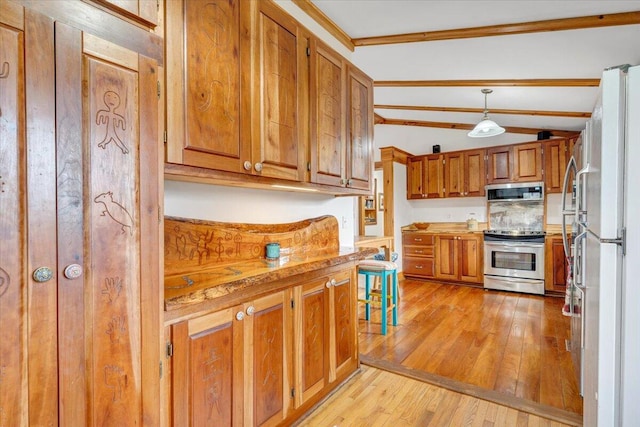 kitchen featuring appliances with stainless steel finishes, light wood-type flooring, ornamental molding, pendant lighting, and lofted ceiling