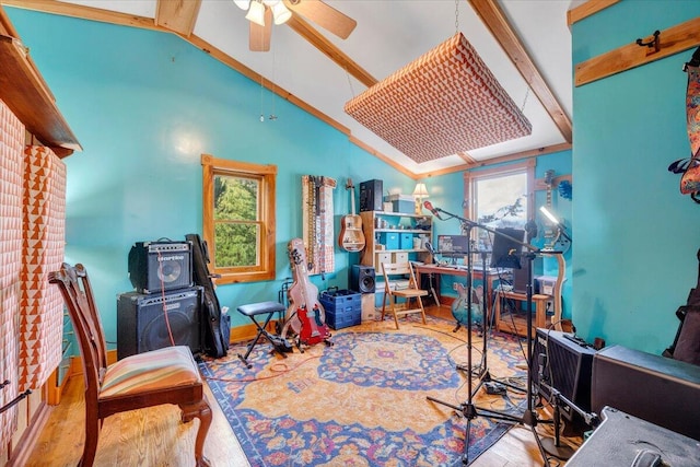 office space featuring vaulted ceiling with beams, light hardwood / wood-style floors, and ceiling fan