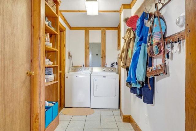 clothes washing area with electric panel, laundry area, washer and clothes dryer, and light tile patterned flooring