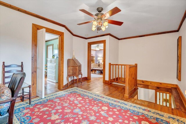 interior space featuring light wood-type flooring and ornamental molding