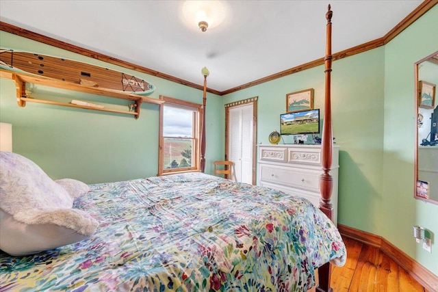 bedroom with wood-type flooring and ornamental molding